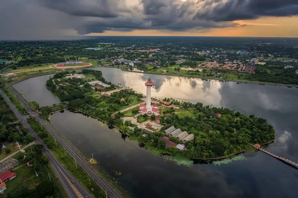 A lakeside park with a white tower, seen from the air
