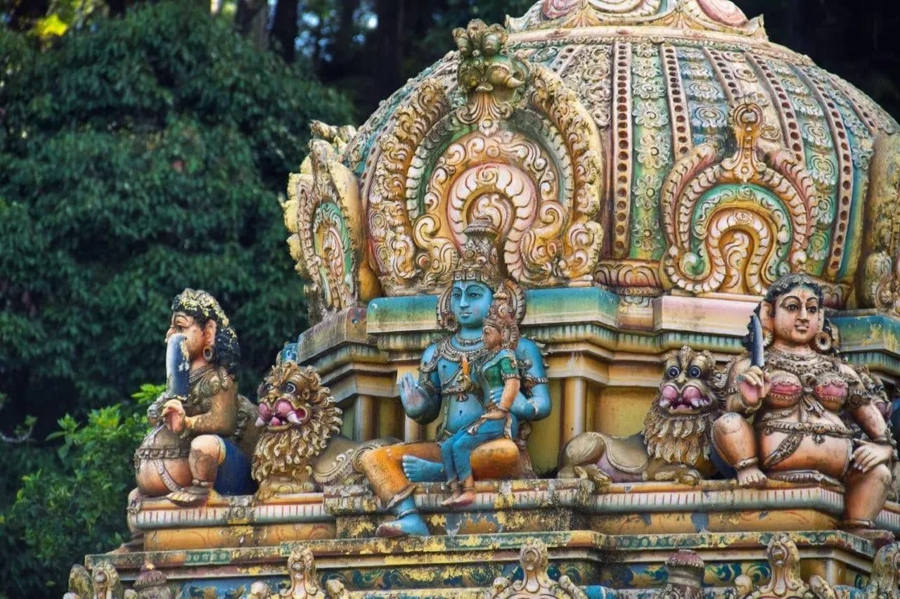 Colourful carved figures on a Hindu temple tower