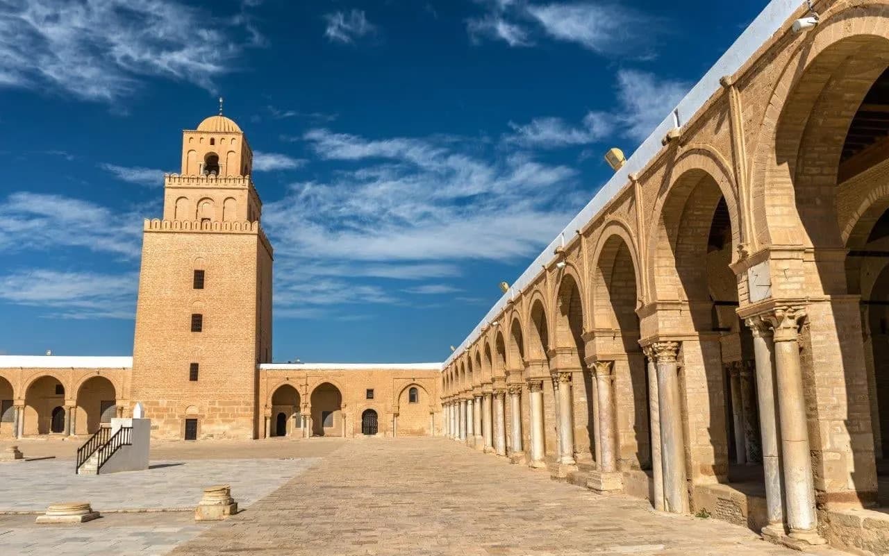 The square minaret and arched courtyard of the Great Mosque of Kairouan