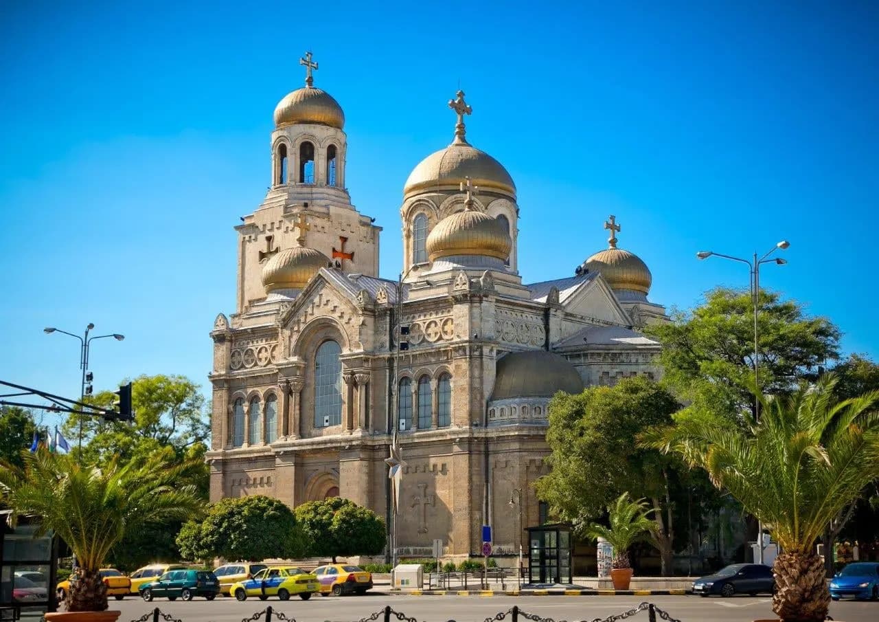 Varna's cathedral with its golden domes, framed by palm trees