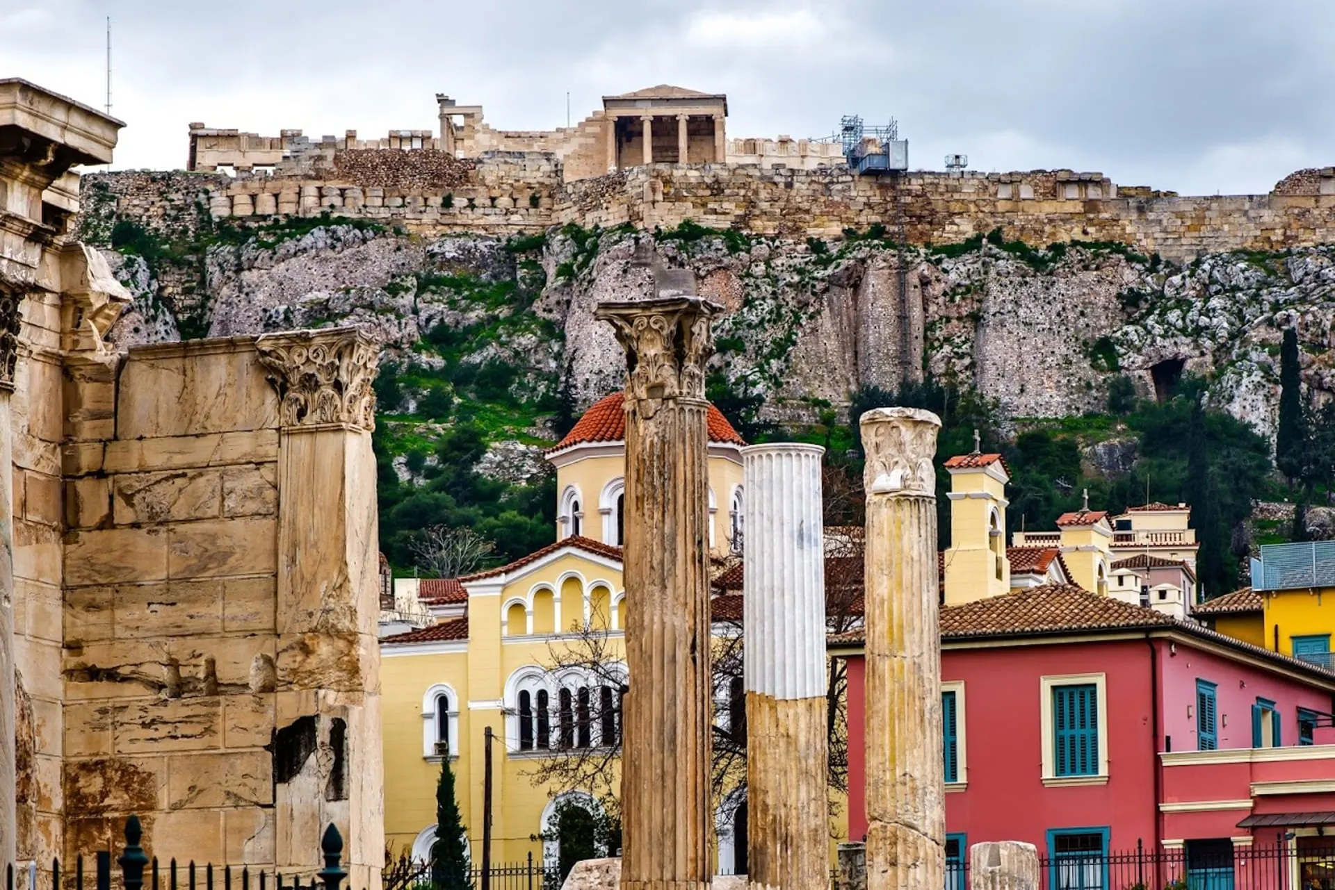 Ancient columns and colourful houses below the Acropolis