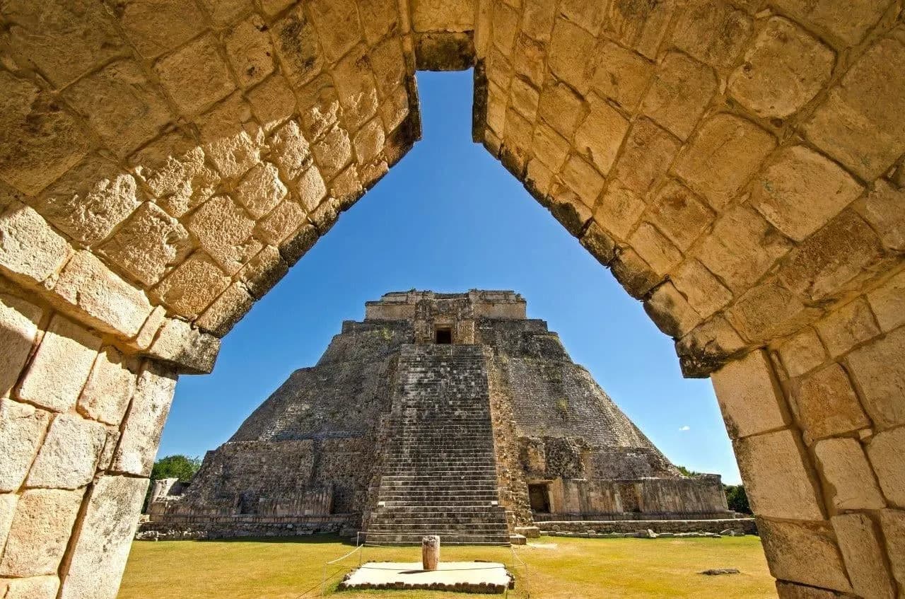 The Pyramid of the Magician at Uxmal framed by a Mayan stone arch