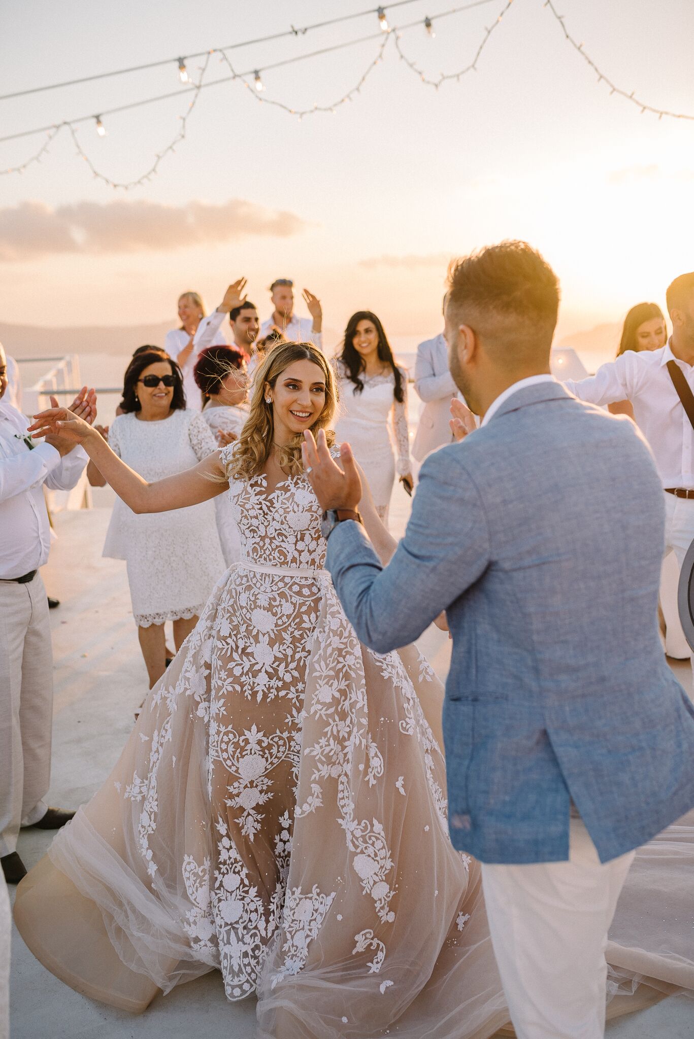 Engagement An all-white wedding set against the santorini sunset
