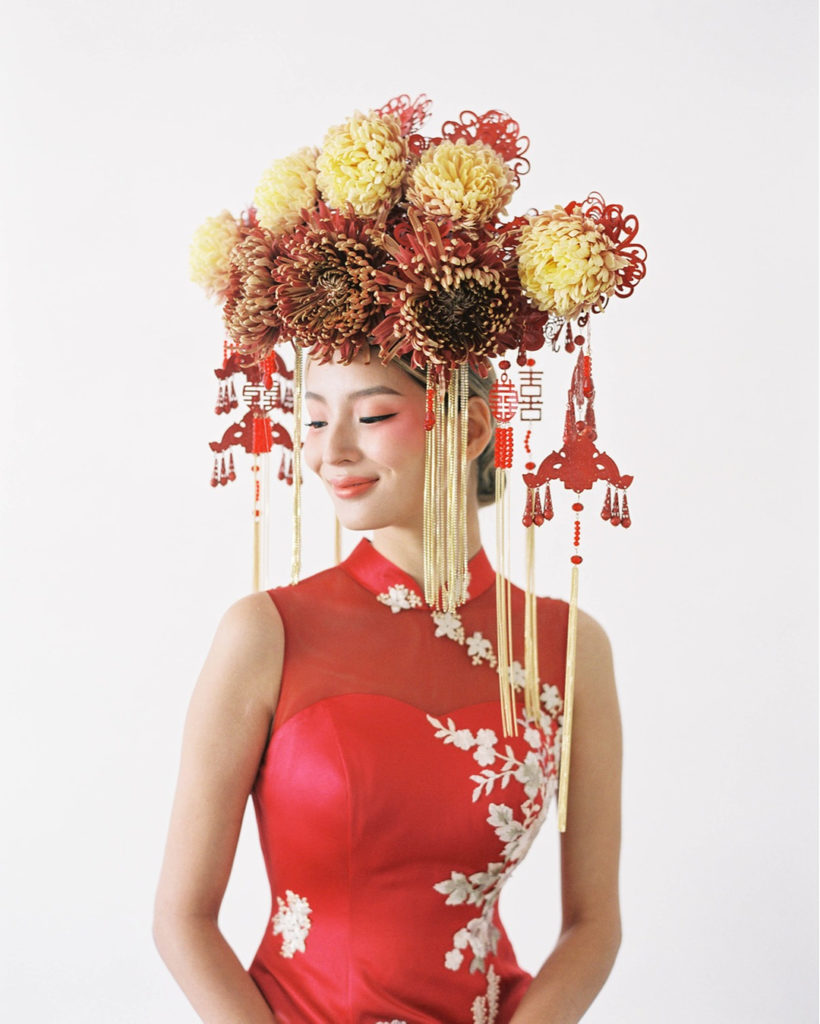 Traditional red Chinese Cheongsam and statement headpiece with flowers and ornaments