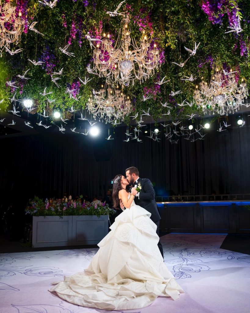 Bride and groom under iconic ceiling installation