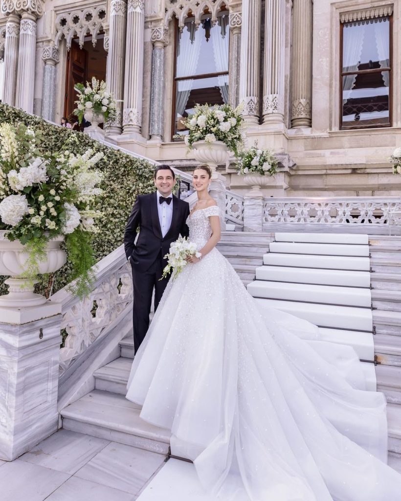 Elegant couple by their destination wedding location the Ciragan Palace in Türkiye