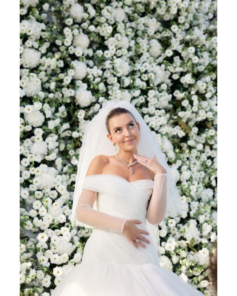 Flawless bride surrounded by white and green flowers