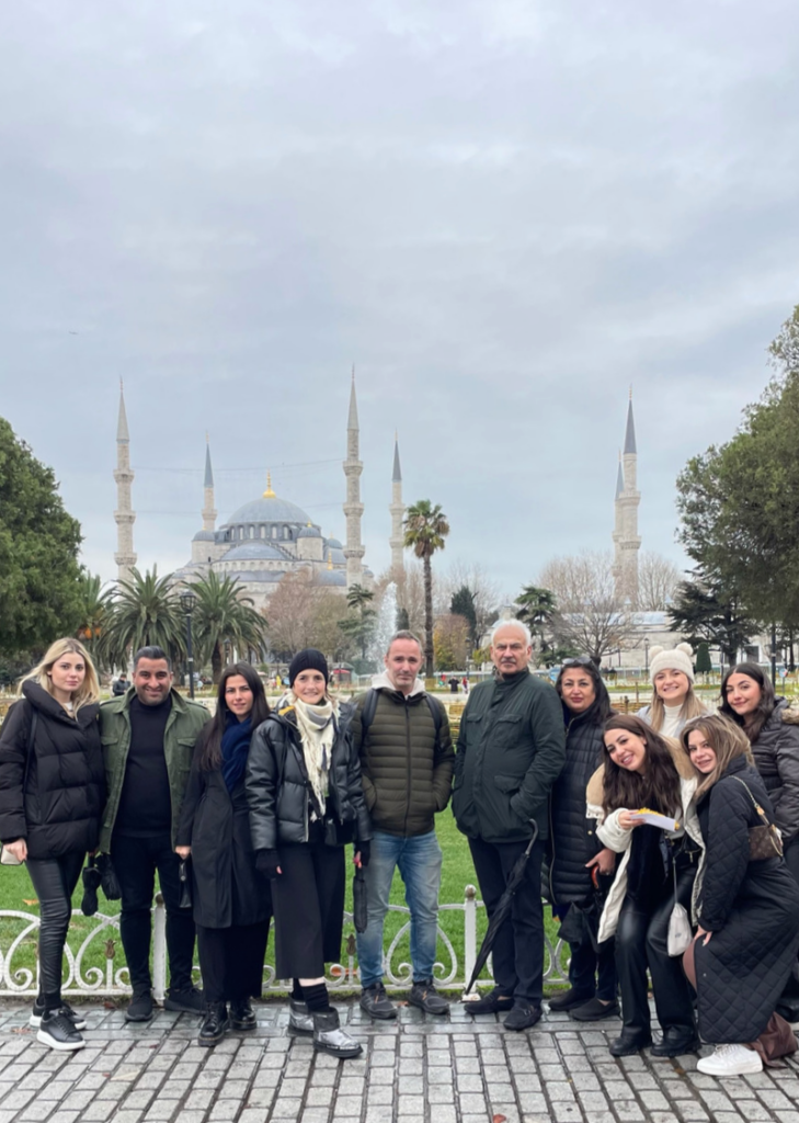 Turkey Tourism group posing with Hagia Sophia behind them.
