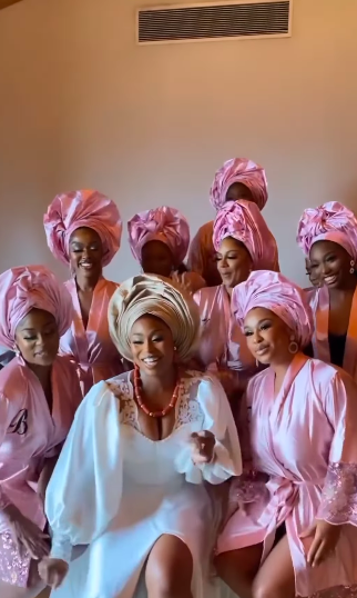 Bride and bridesmaids wearing nude and bright pink gele headwraps
