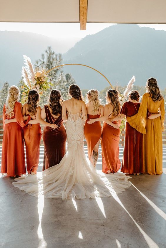 The bride and her entourage dressed in hues of terracotta, copper, and burnt sienna