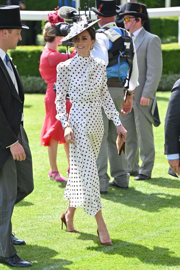 Stylish polka dot dress matched with a fascinator and brown pumps