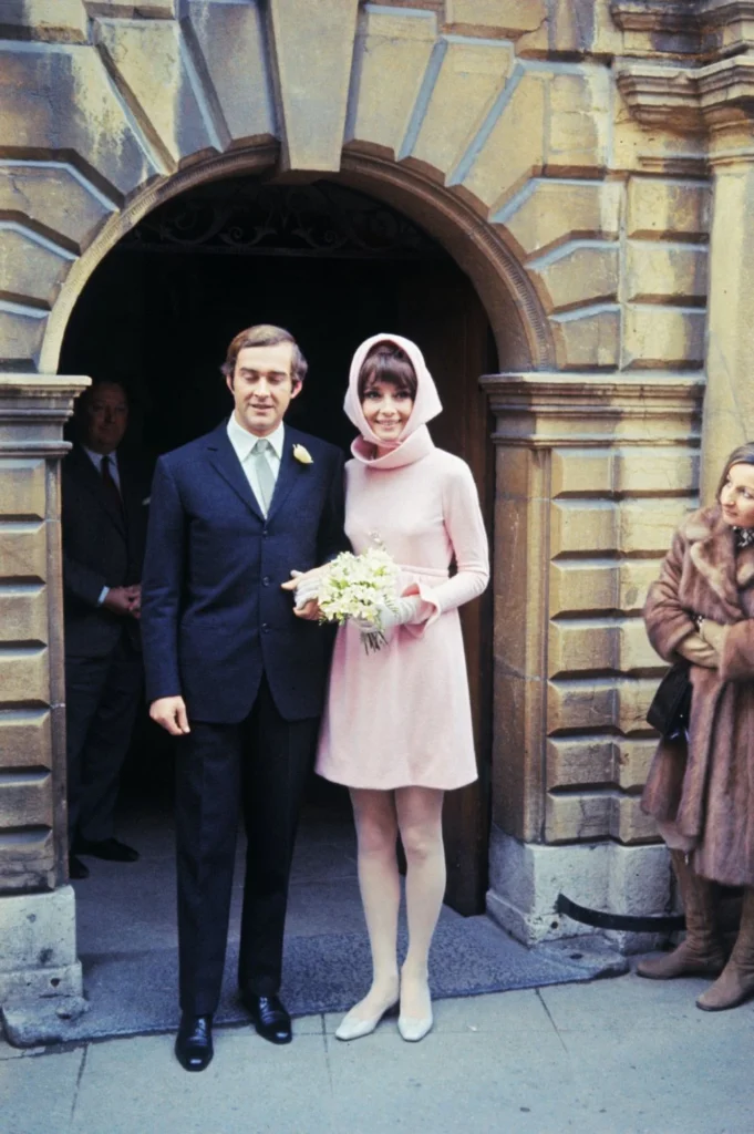 Audrey Hepburn in a pink short wedding dress.