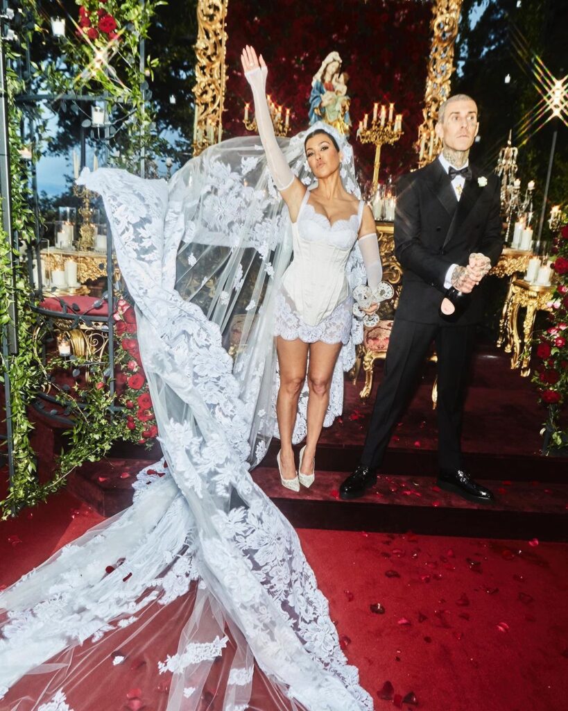 Kourtney Kardashian and Travis Baker wedding wearing short wedding dress a 2023 bridal trend.