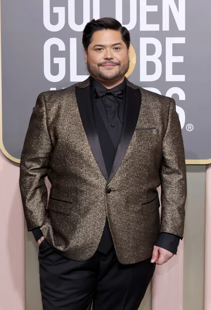 Harvey Guillen adds luxury to the Golden Globes red carpet with a tailored suit featuring gold detailing