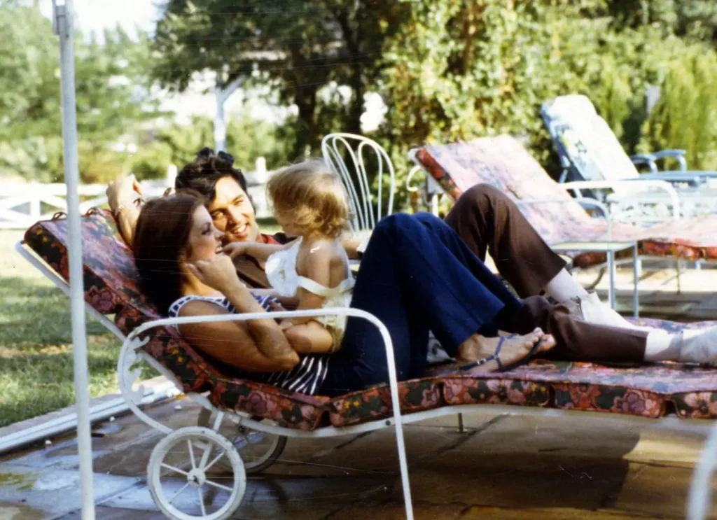 The legendary family Priscilla, Elvis, and Lisa Marie Presley on a day bed spending quality time together