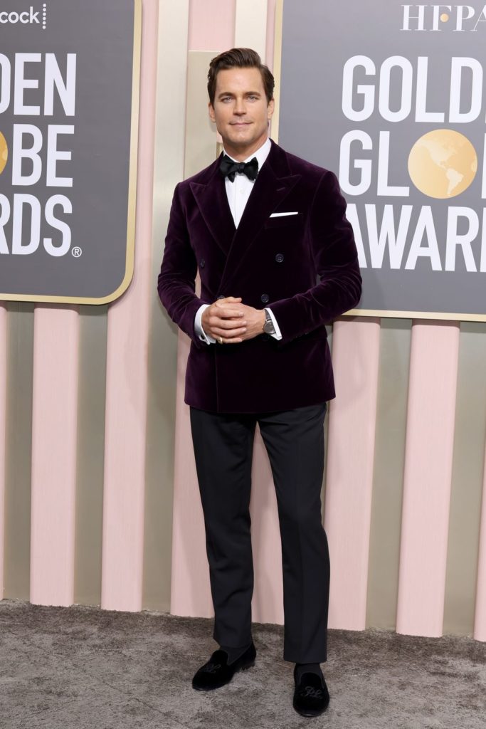 Matt Bomer on the red carpet with a dark purple velvet Ralph Lauren tuxedo