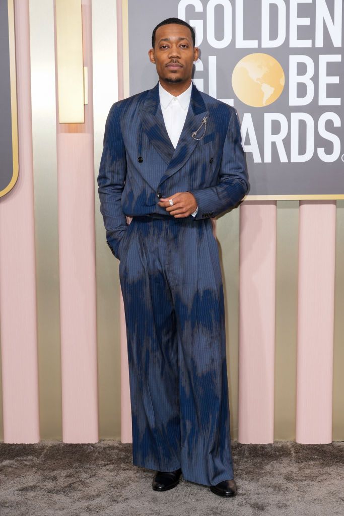 Tyler James Williams on the red carpet with a washed-out cropped Matador-style suit by streetwear brand Amiri