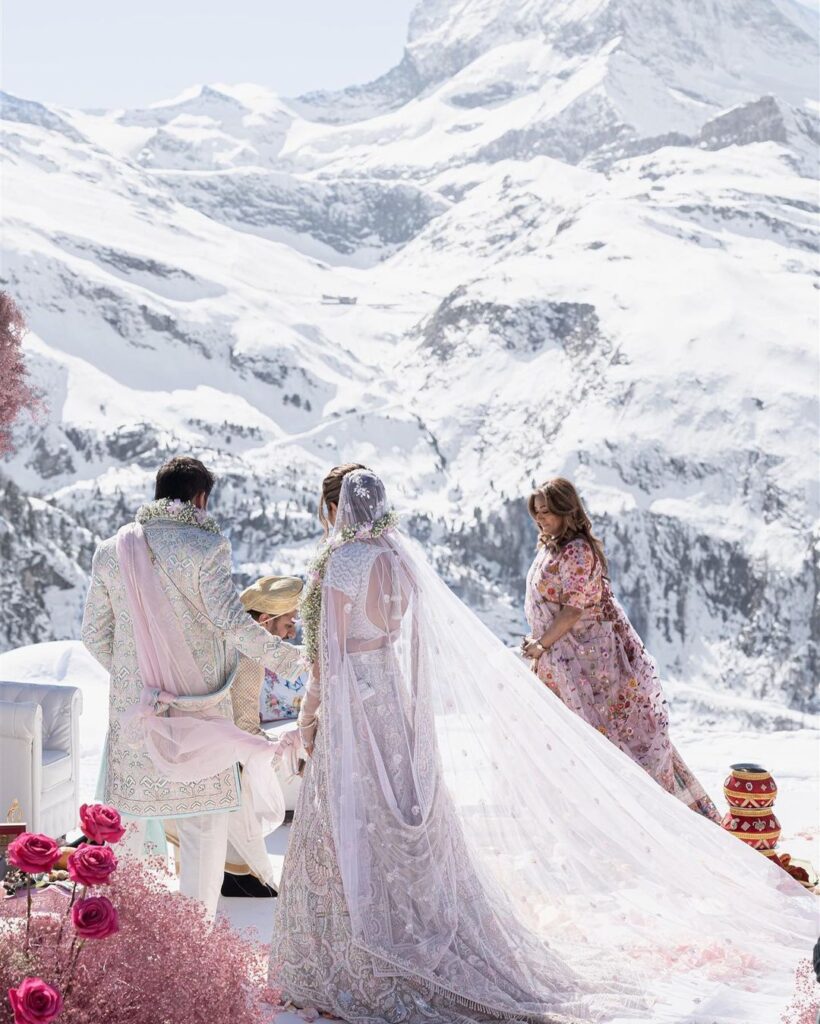Beautiful Indian bride and groom having a traditional ceremony in the Swiss mountains