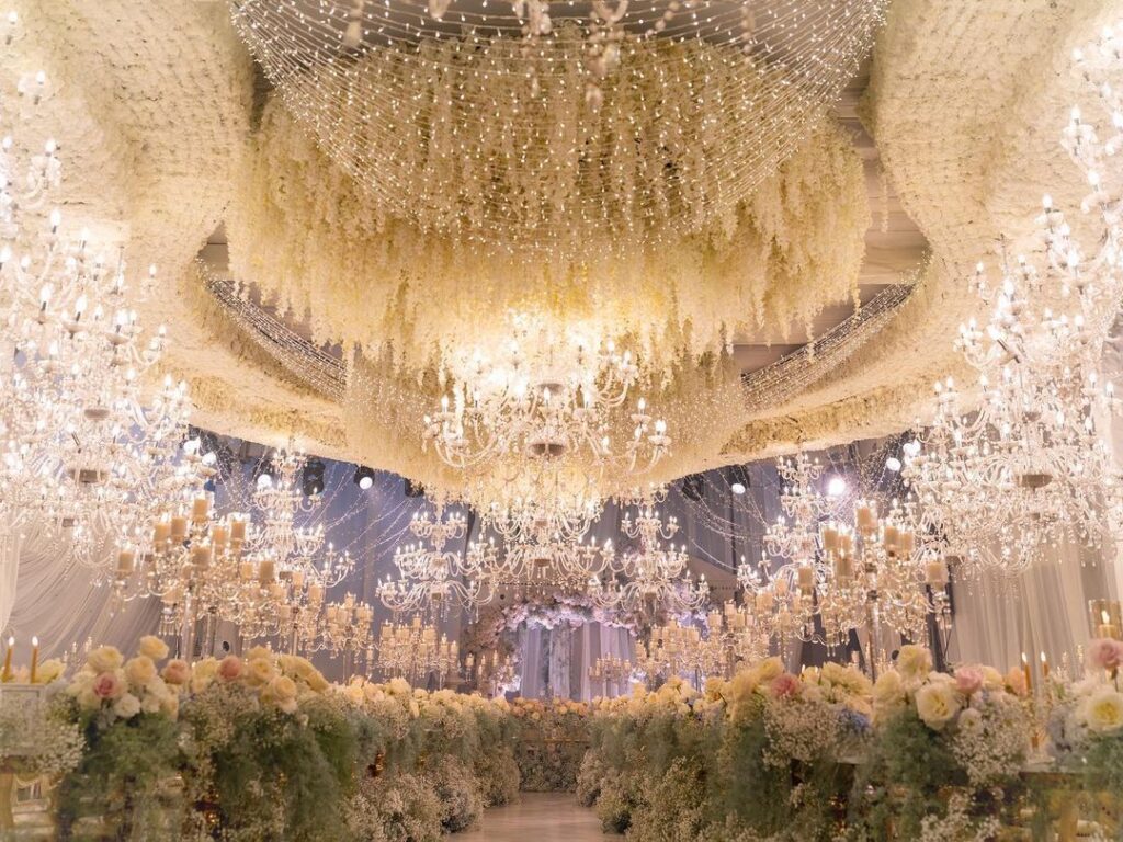 Beautiful venue full of flower installations and glimmering chandeliers. 