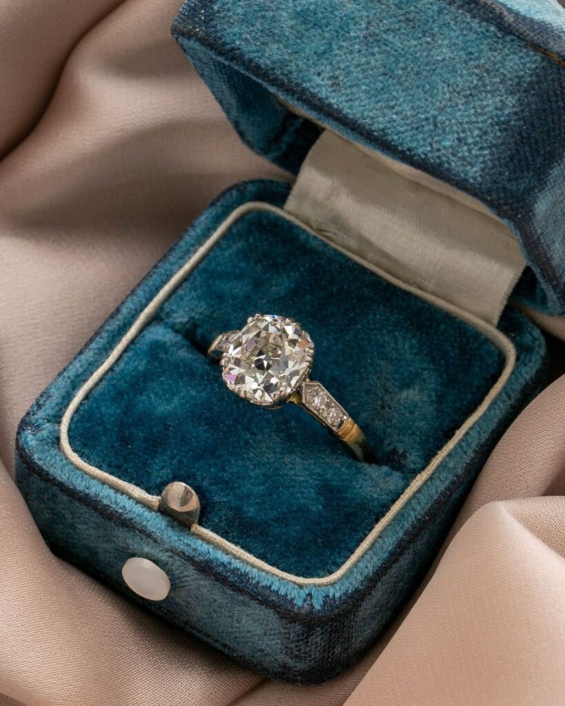 Timeless vintage engagement ring in a blue box.