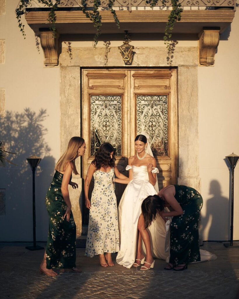 Bride with her bridesmaids in front of her venue