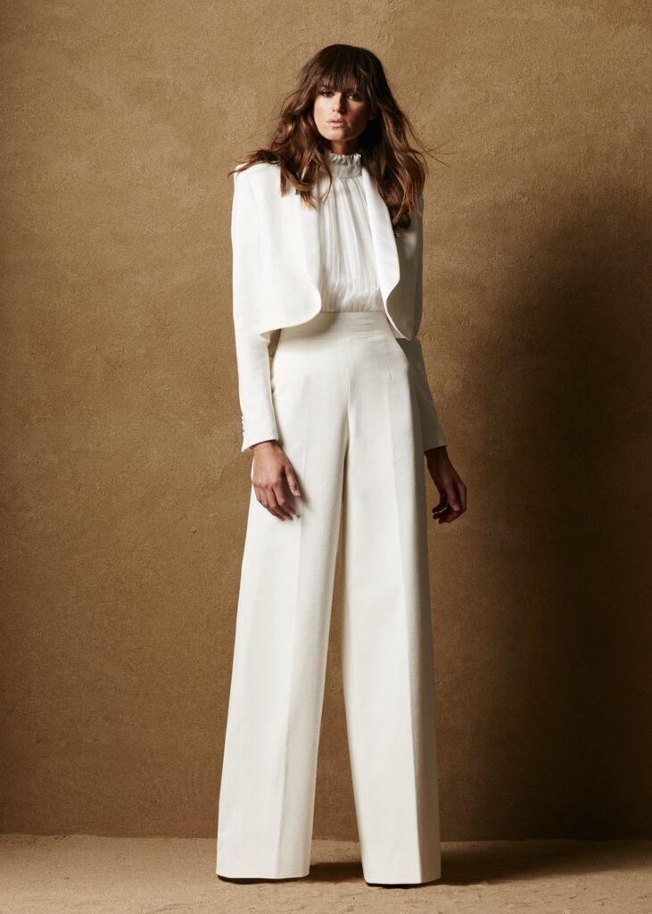 Cropped white blazer paired with wide leg trousers