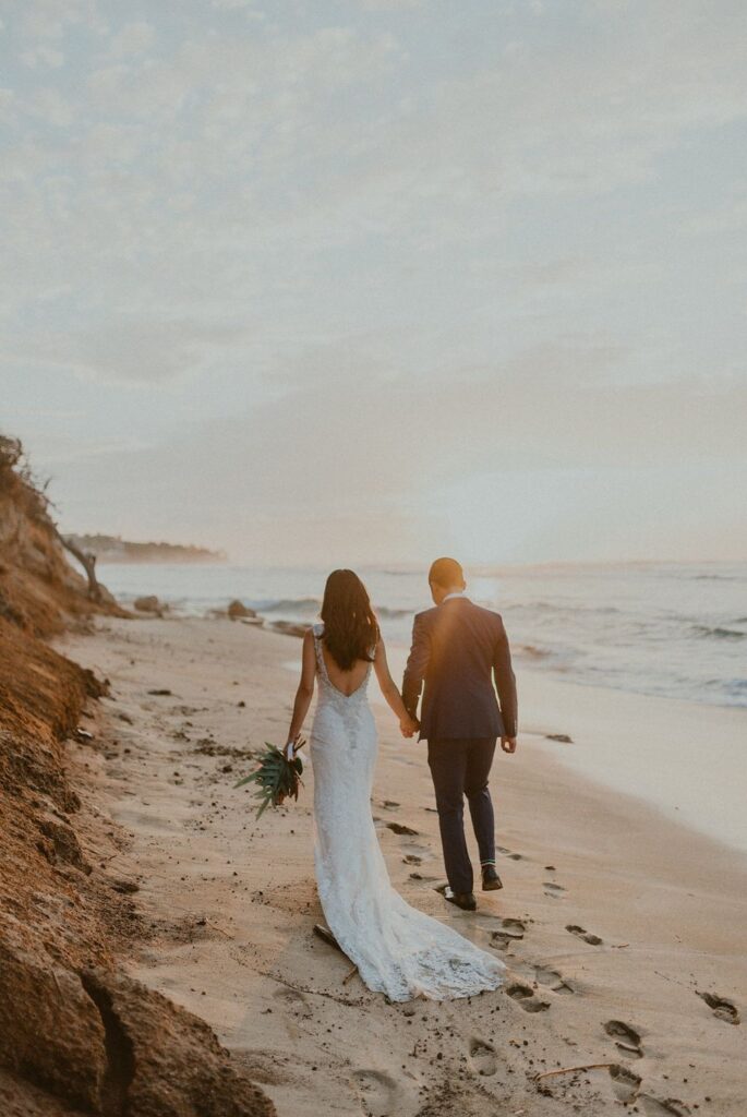 Beautiful couple walking off into the sunset in Hawaii.