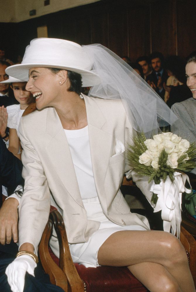Ines de la Fressange in her effortless chic bridal suit and veiled hat