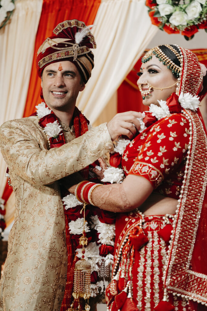 Bride and groom enjoying traditional Indian wedding customs. 
