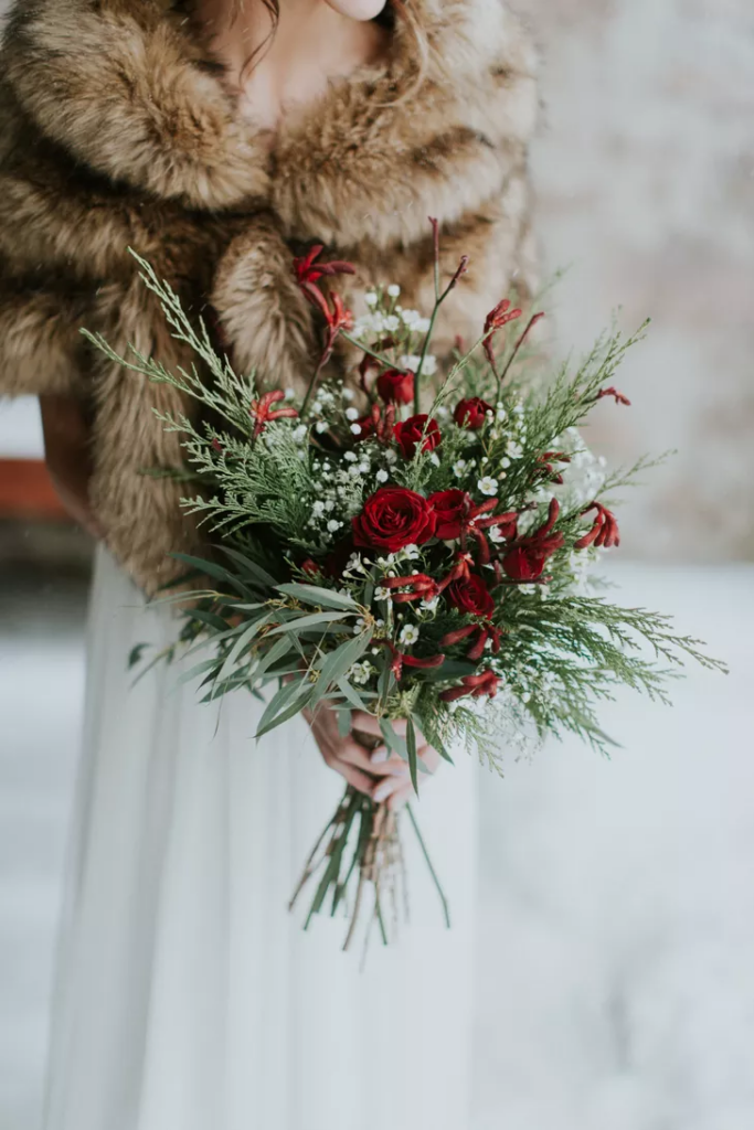 Winter wedding bouquets with red and green florals.