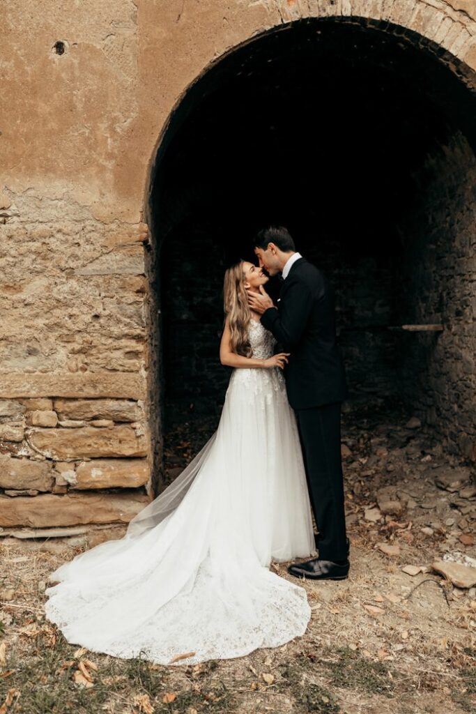 Couple being photographed around ruins in Italy.
