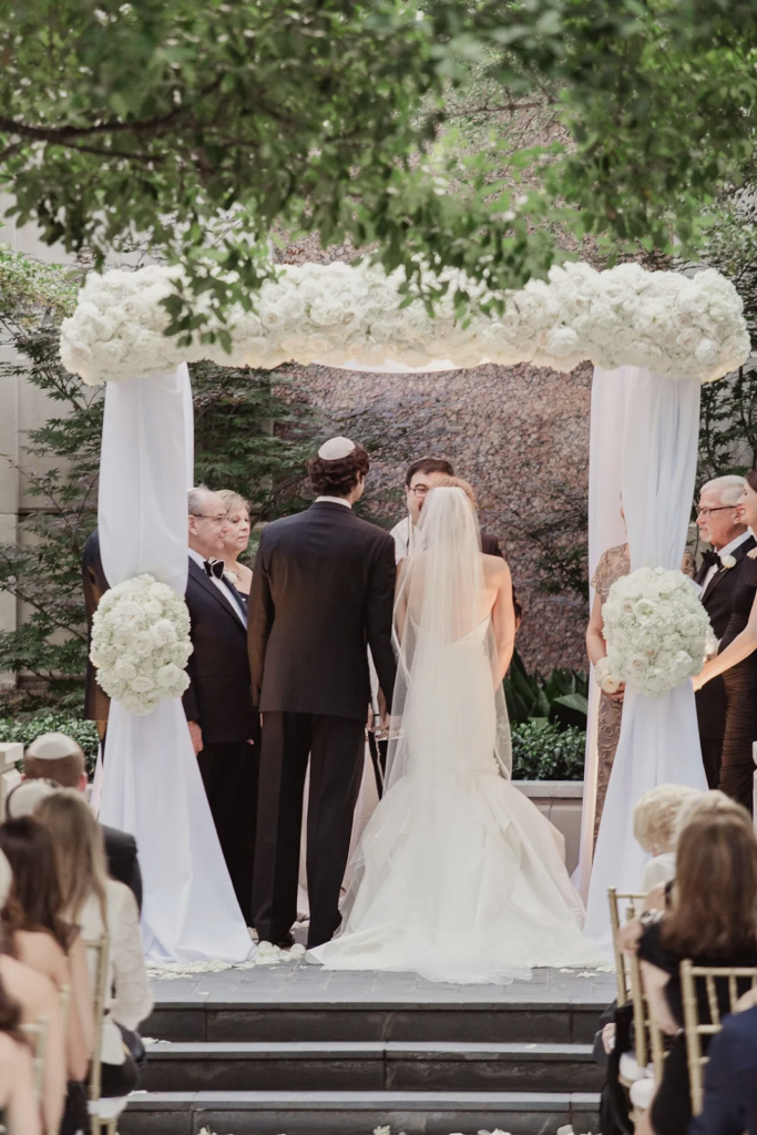 Jewish bride and groom getting married under the chuppah.