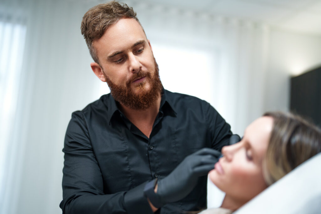 Cosmetic wedding prep Dr. Josh Wall works on patients face.