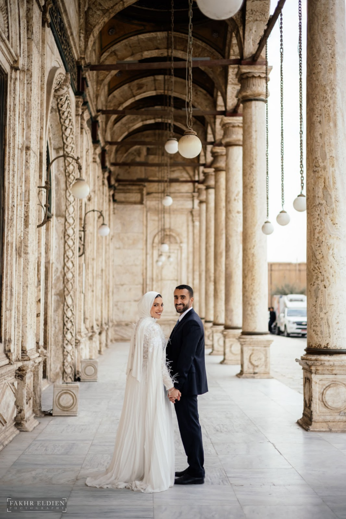 The bride and groom holding hands in this beautiful venue.