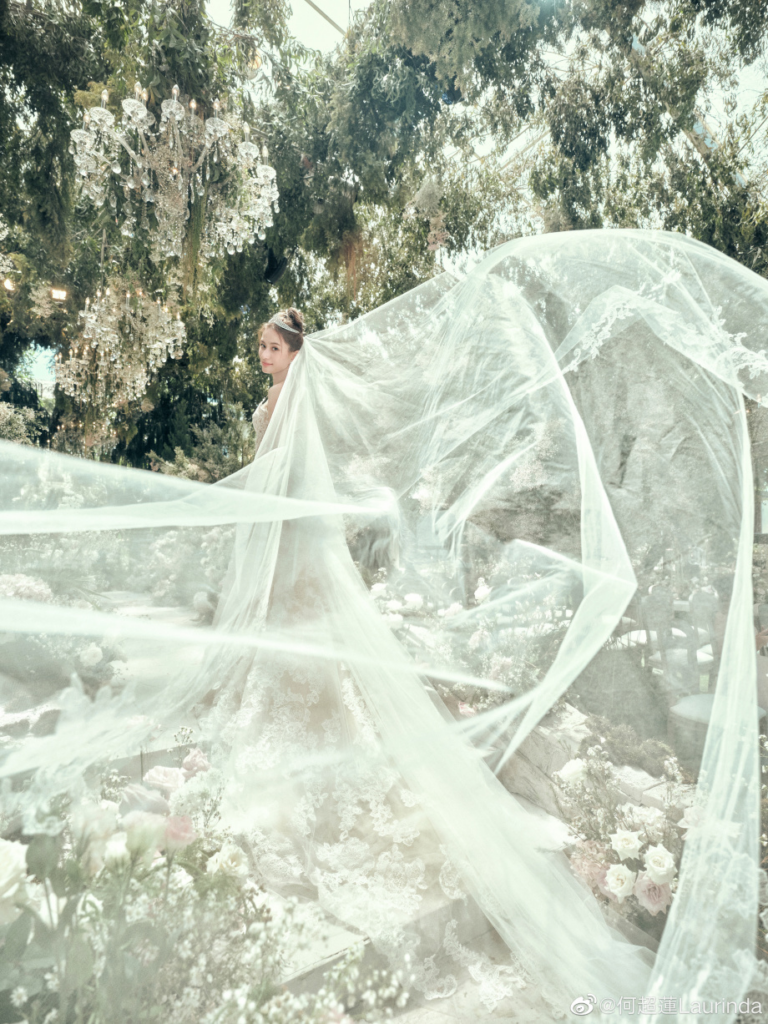 The beautiful bride in this magical shot with her veil in a stunning garden.
