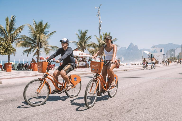 The Ultimate Guide To Having A Honeymoon in Brazil - image of two persons riding cycles on beach