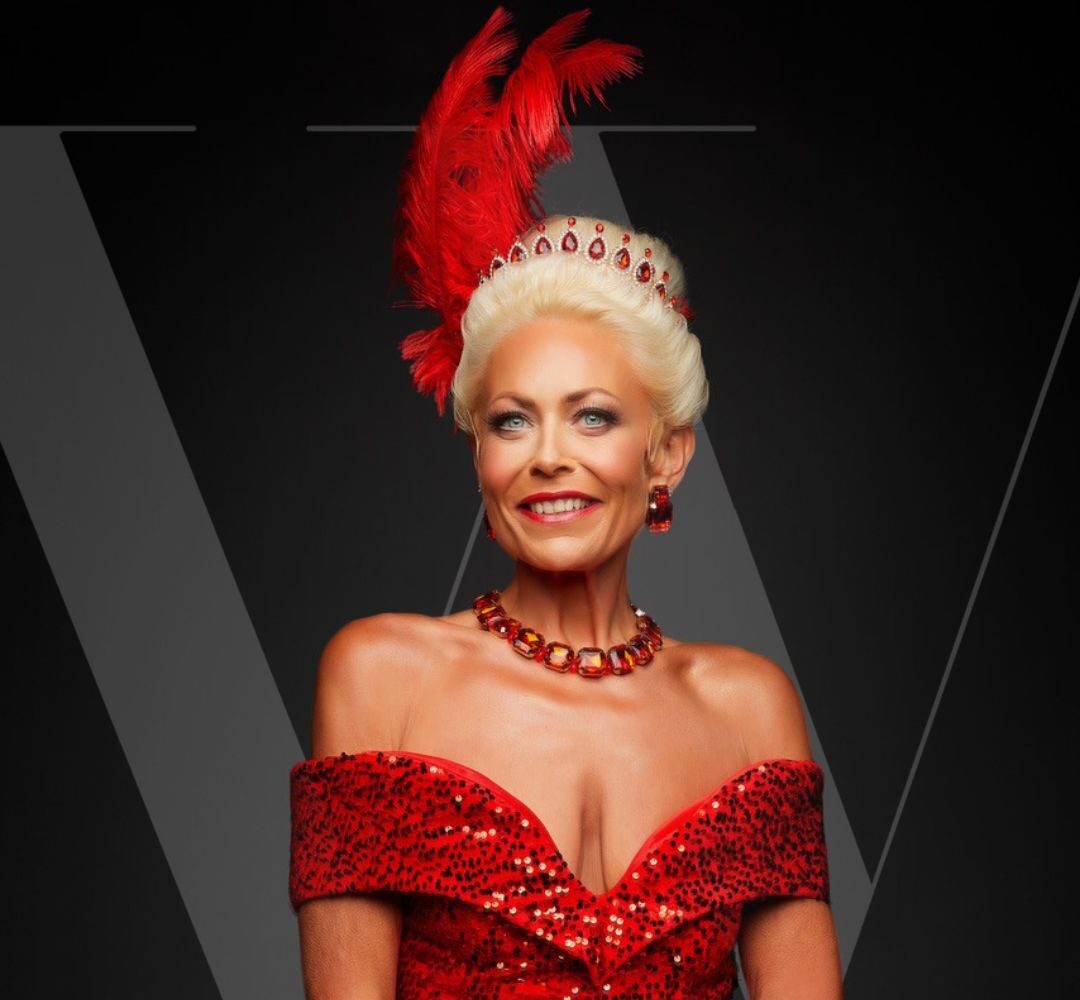 Elegant woman in a sparkling red gown with feathered headpiece, showcasing luxury wedding fashion and glamour.