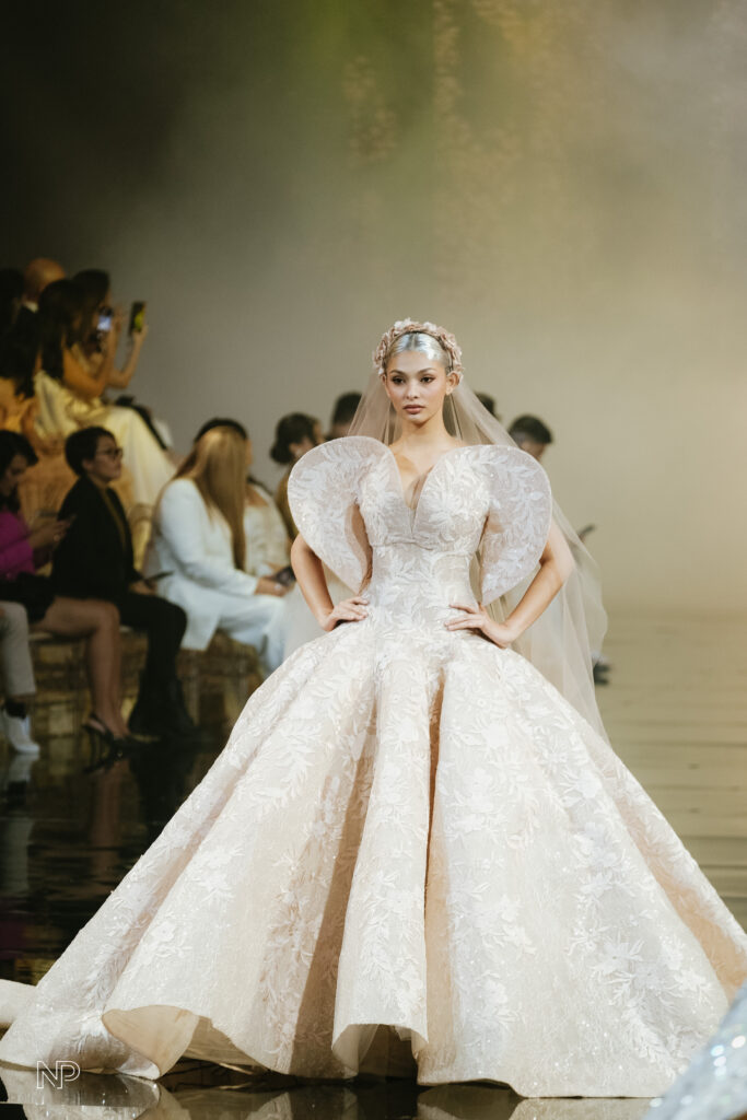 The World Has Been GIDEONIZED With A Bridal Fashion Extravaganza In The Philippines: Marry Me At Marriott X Gideon Hermosa 13 Model showcasing a stunning bridal gown with dramatic puffed sleeves and intricate floral embroidery on the runway at the Philippine Gratus Gala, celebrating Filipino bridal fashion designers.