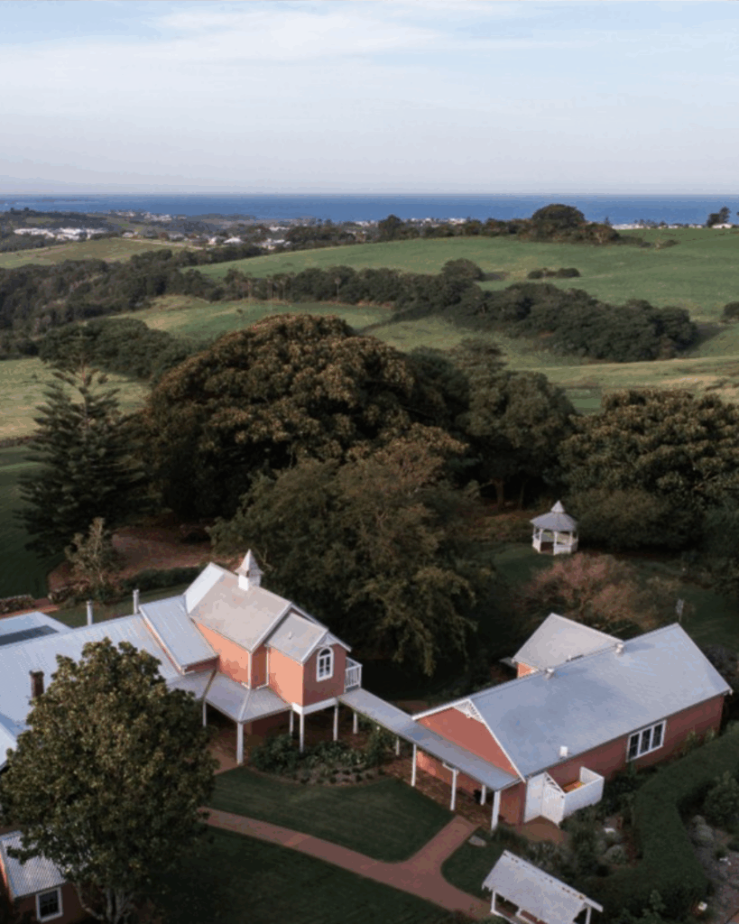100 Breathtaking and Exclusive Australian Wedding Venues on every Couples Wish List! 4 Aerial view of Greyleigh wedding venue showcasing historic buildings, lush green landscape, and the Gazebo, ideal for intimate ceremonies in Kiama, NSW.