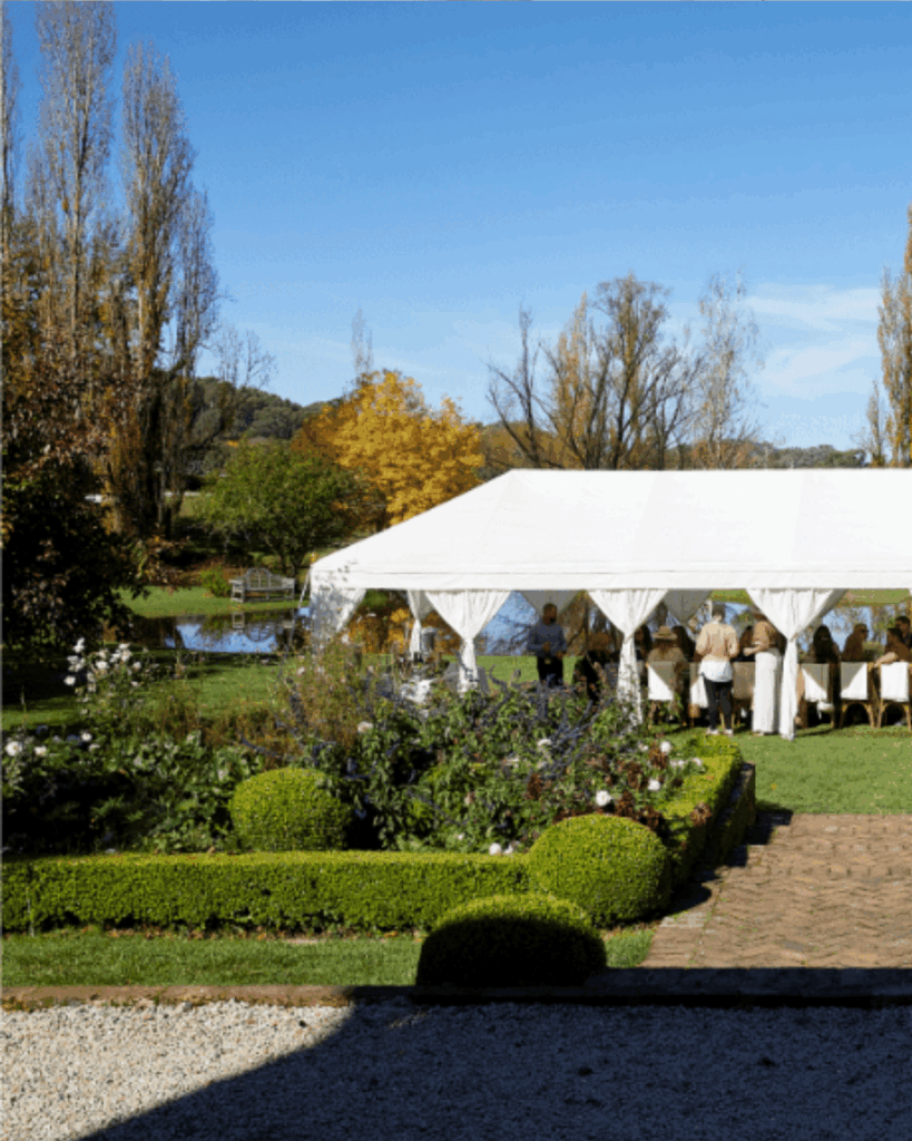 100 Breathtaking and Exclusive Australian Wedding Venues on every Couples Wish List! 61 Rosedale Farm outdoor wedding venue featuring a white marquee set up on the front lawn, surrounded by manicured gardens and autumn foliage.